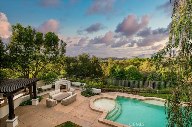 pool at dusk with a patio