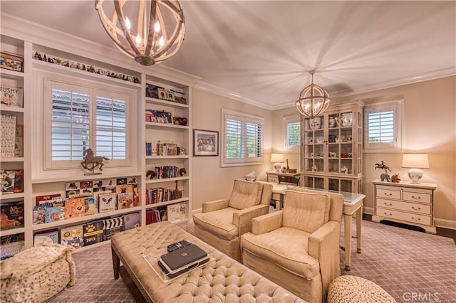 living area featuring an inviting chandelier, crown molding, baseboards, and a healthy amount of sunlight