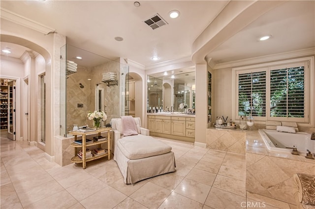 bathroom with plus walk in shower, ornamental molding, tile patterned floors, and vanity