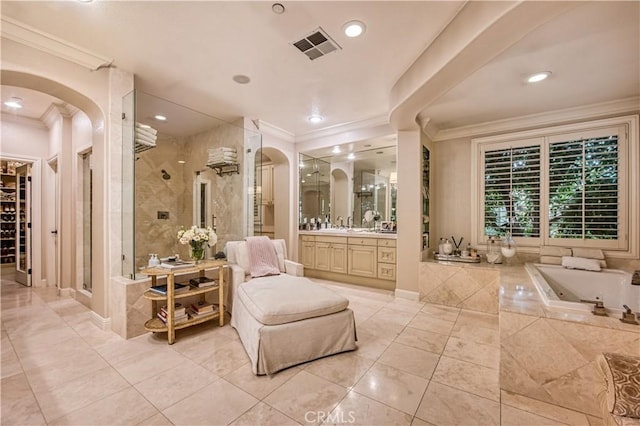 bathroom featuring visible vents, a stall shower, crown molding, a bath, and vanity