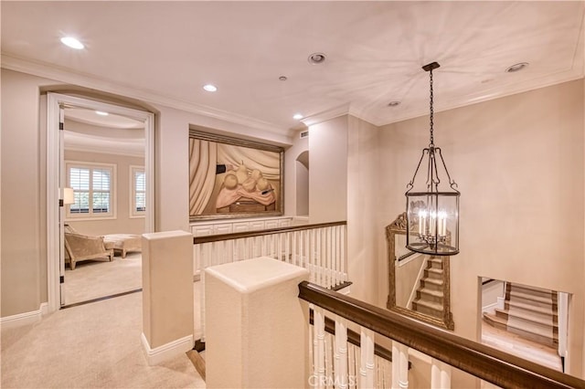 corridor with baseboards, recessed lighting, an upstairs landing, crown molding, and light colored carpet