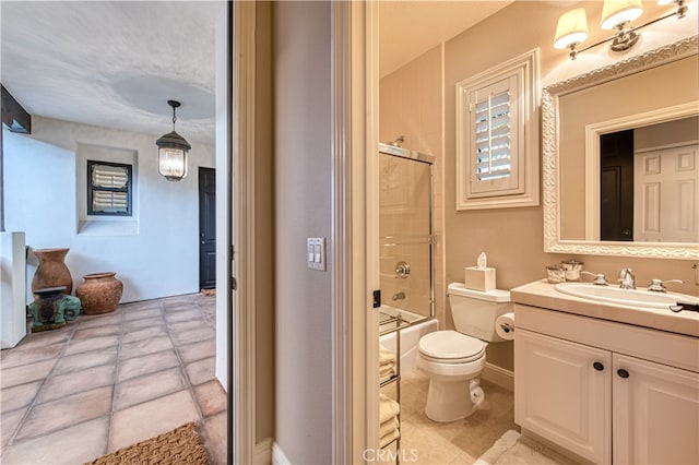 full bathroom with combined bath / shower with glass door, vanity, toilet, and tile patterned floors