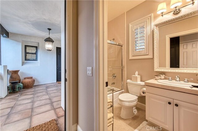 full bathroom featuring vanity, baseboards, bath / shower combo with glass door, tile patterned floors, and toilet