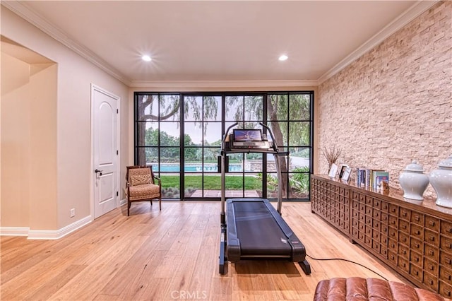 workout room with crown molding, recessed lighting, wood finished floors, and baseboards