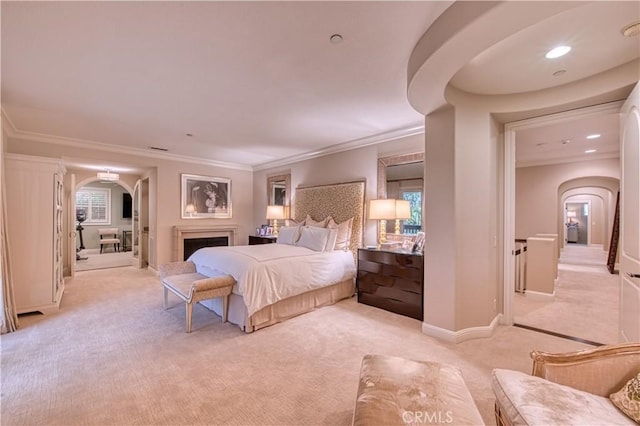 bedroom featuring baseboards, light colored carpet, ornamental molding, recessed lighting, and arched walkways