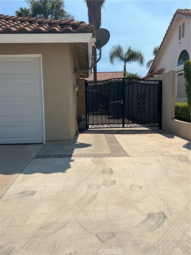 view of gate with a garage