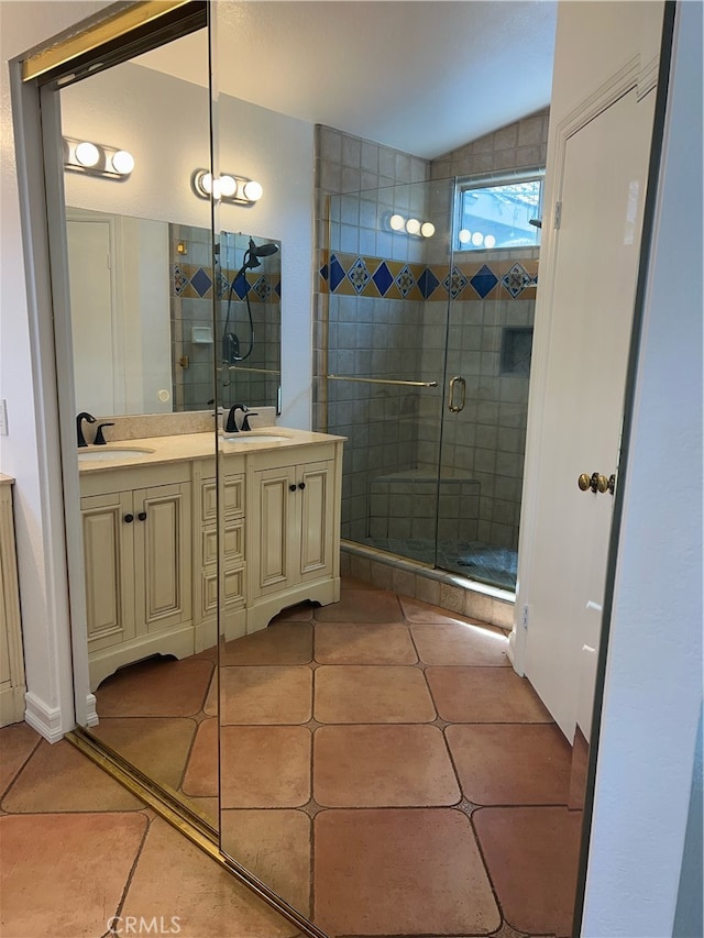 bathroom featuring tile patterned floors, an enclosed shower, and vanity