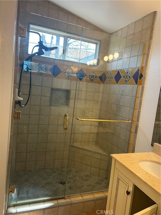 bathroom with walk in shower, vanity, and lofted ceiling