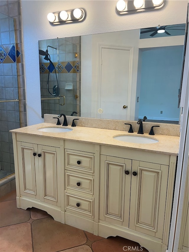 bathroom with tile patterned flooring, a shower with door, and vanity