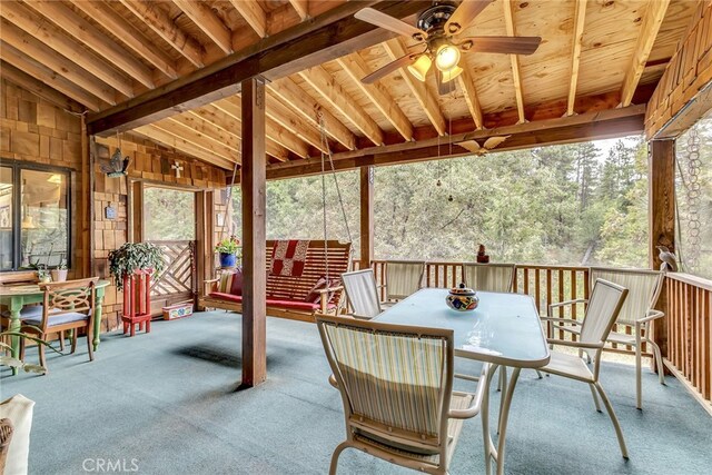 sunroom / solarium featuring lofted ceiling with beams and ceiling fan