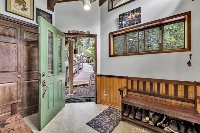 foyer featuring wood walls