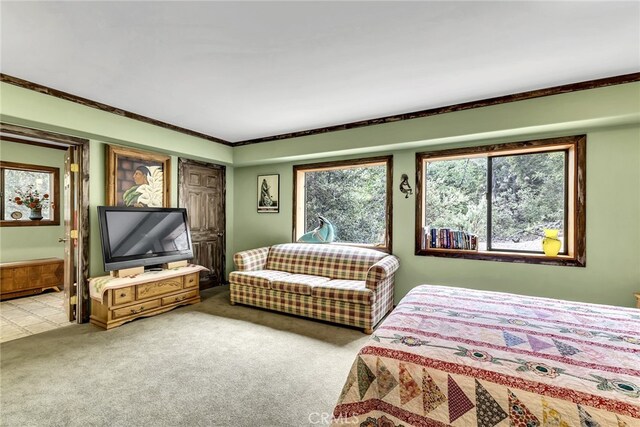 bedroom featuring ornamental molding and light colored carpet