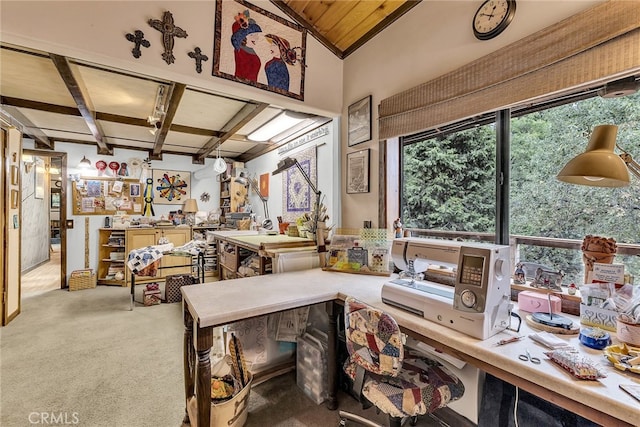 misc room with beam ceiling, a workshop area, and light colored carpet