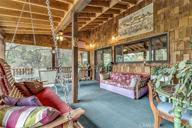 sunroom / solarium with wooden ceiling, vaulted ceiling, and ceiling fan