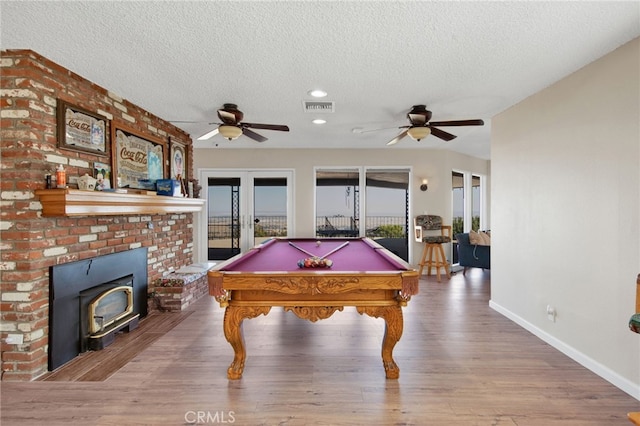 playroom featuring billiards, a textured ceiling, wood-type flooring, ceiling fan, and french doors