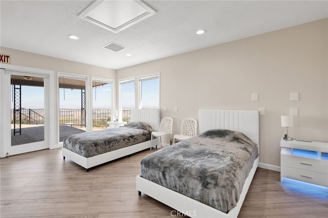 bedroom featuring access to outside and hardwood / wood-style flooring