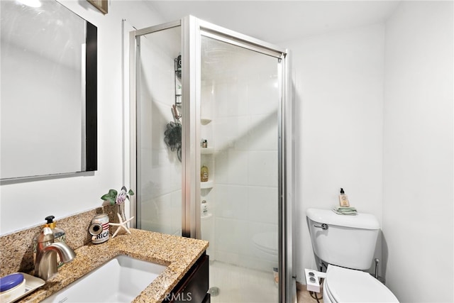 bathroom featuring vanity, toilet, and walk in shower