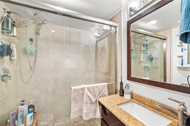 bathroom with vanity and an enclosed shower