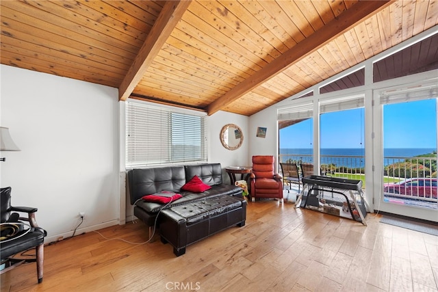 sunroom with vaulted ceiling with beams, a healthy amount of sunlight, a water view, and wood ceiling