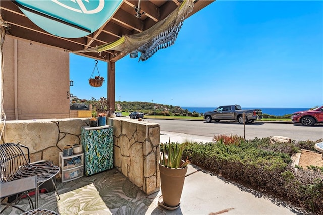 view of patio / terrace with a water view