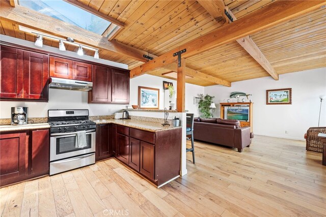 kitchen featuring wooden ceiling, a skylight, light hardwood / wood-style flooring, stainless steel gas stove, and beam ceiling