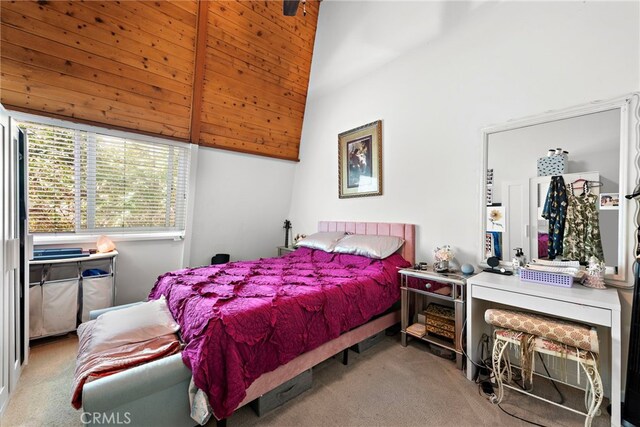 carpeted bedroom with beam ceiling and high vaulted ceiling