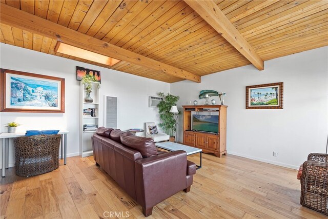 living room with beam ceiling, a skylight, light wood-type flooring, and wooden ceiling