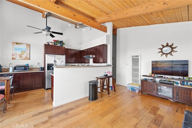 kitchen with wooden ceiling, high vaulted ceiling, light wood-type flooring, beamed ceiling, and stainless steel appliances