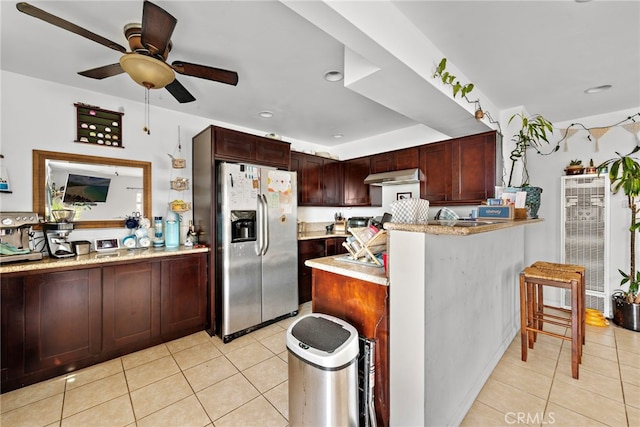 kitchen with kitchen peninsula, ceiling fan, range hood, light tile patterned flooring, and stainless steel fridge with ice dispenser