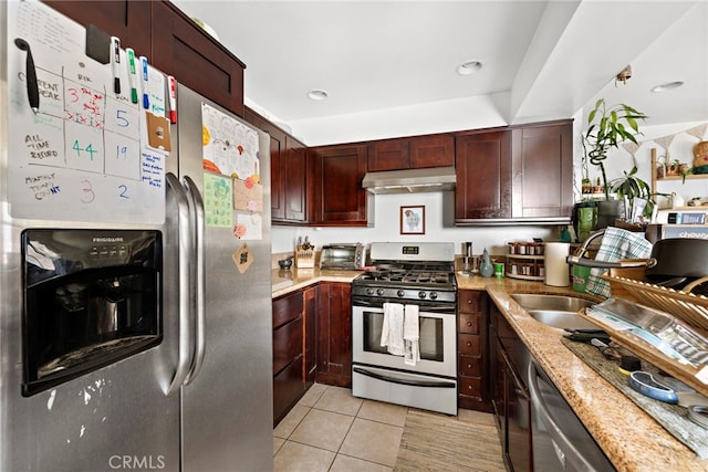 kitchen featuring light tile patterned floors, light stone countertops, and appliances with stainless steel finishes