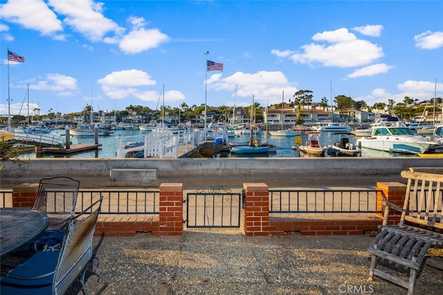 exterior space with a water view and a boat dock