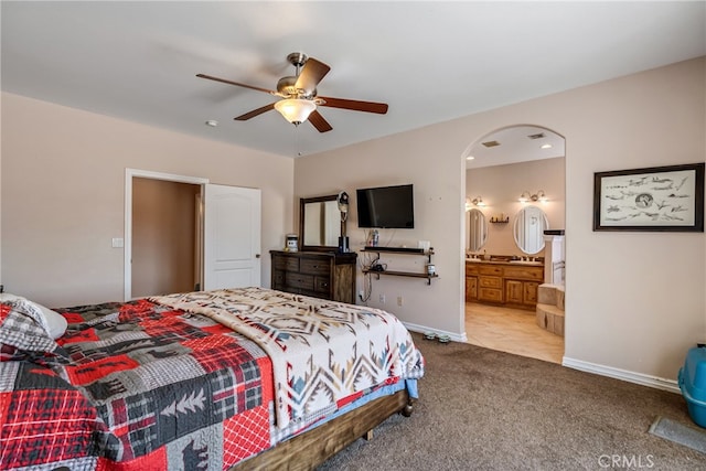 carpeted bedroom with ceiling fan and ensuite bathroom