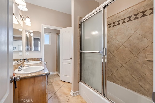 bathroom featuring combined bath / shower with glass door, vanity, and tile patterned flooring