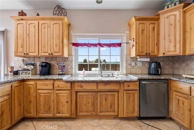 kitchen with backsplash, light tile patterned flooring, dishwasher, and sink