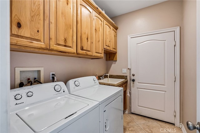 laundry room with cabinets, independent washer and dryer, light tile patterned floors, and sink