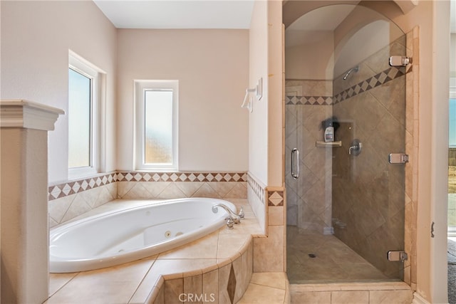 bathroom with separate shower and tub and tile patterned flooring