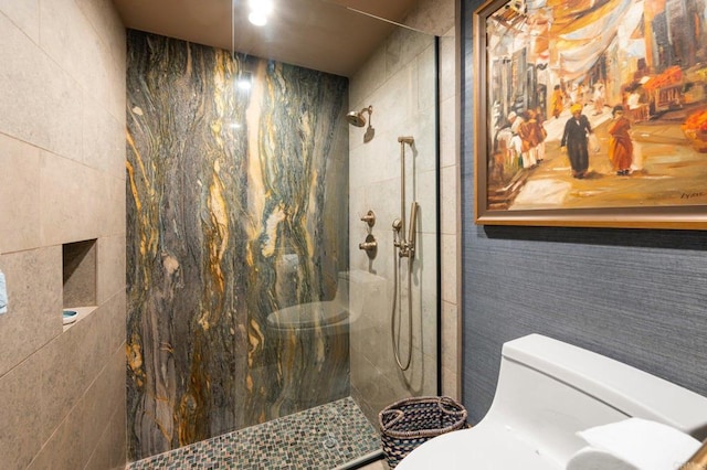 bathroom featuring toilet, tile walls, and tiled shower