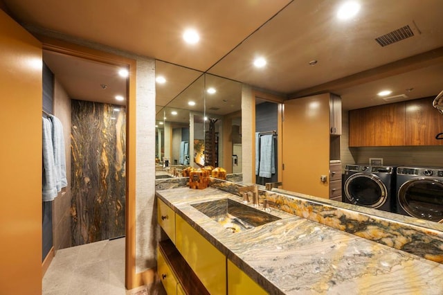 bathroom with vanity and independent washer and dryer