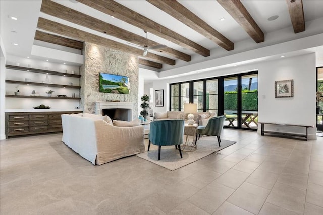 living room featuring beam ceiling, a stone fireplace, light tile patterned flooring, and french doors