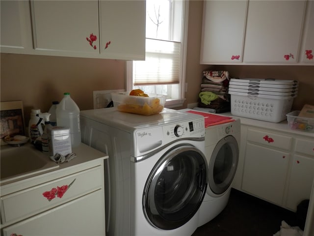 washroom featuring cabinets and independent washer and dryer