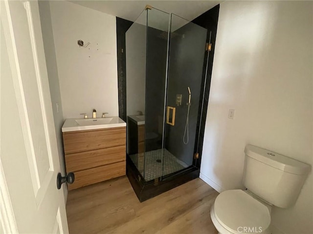 16003 Baker Canyon Rd, Canyon Country, CA 91390 - bathroom with a stall shower, toilet, wood finished floors, and vanity