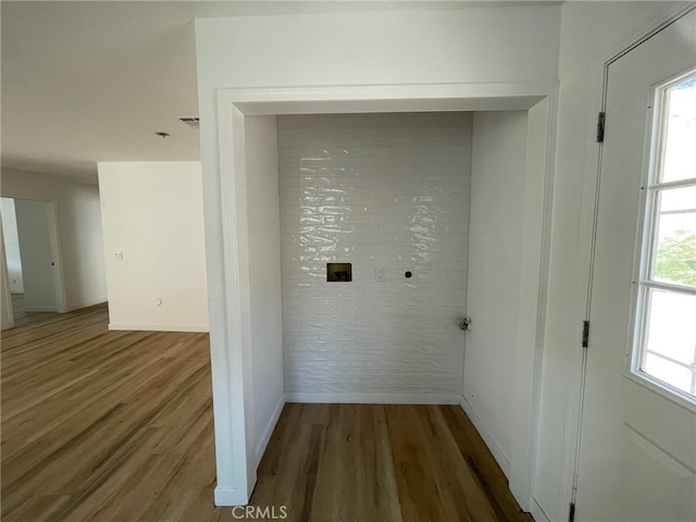 laundry room with wood-type flooring, plenty of natural light, and hookup for an electric dryer