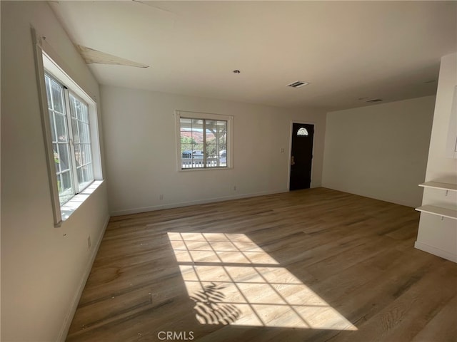 unfurnished room with light hardwood / wood-style flooring