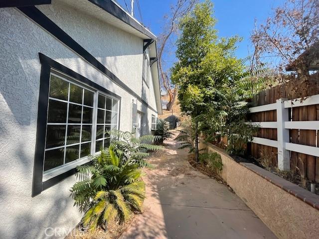 16003 Baker Canyon Rd, Canyon Country, CA 91390 - view of side of home featuring stucco siding and fence
