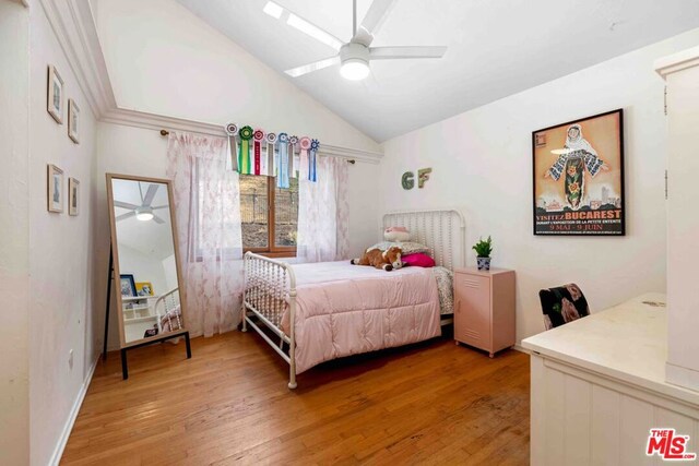 bedroom featuring ceiling fan, hardwood / wood-style floors, and lofted ceiling