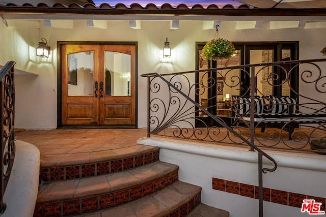 entrance to property featuring french doors