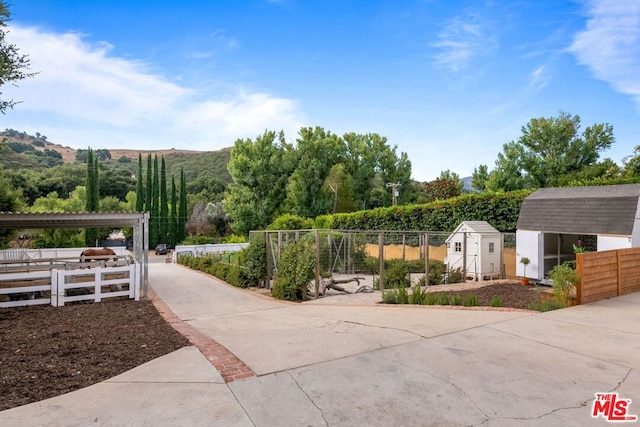 surrounding community featuring a mountain view and a shed