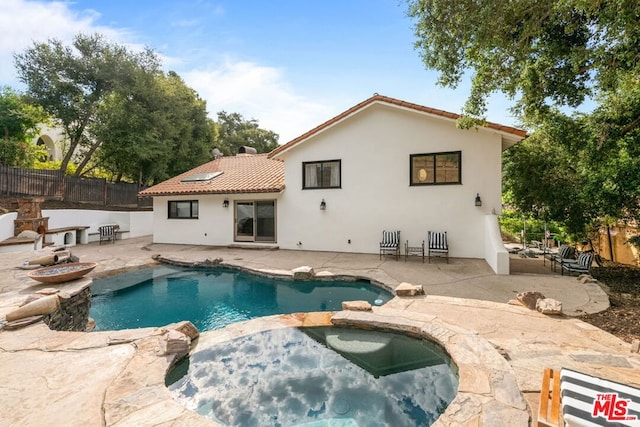 view of pool with an in ground hot tub and a patio