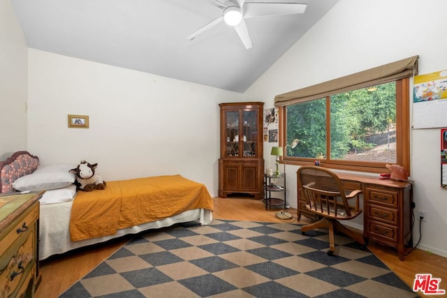 bedroom featuring ceiling fan, dark hardwood / wood-style flooring, and lofted ceiling