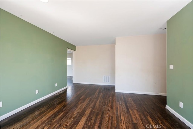 spare room with dark hardwood / wood-style flooring